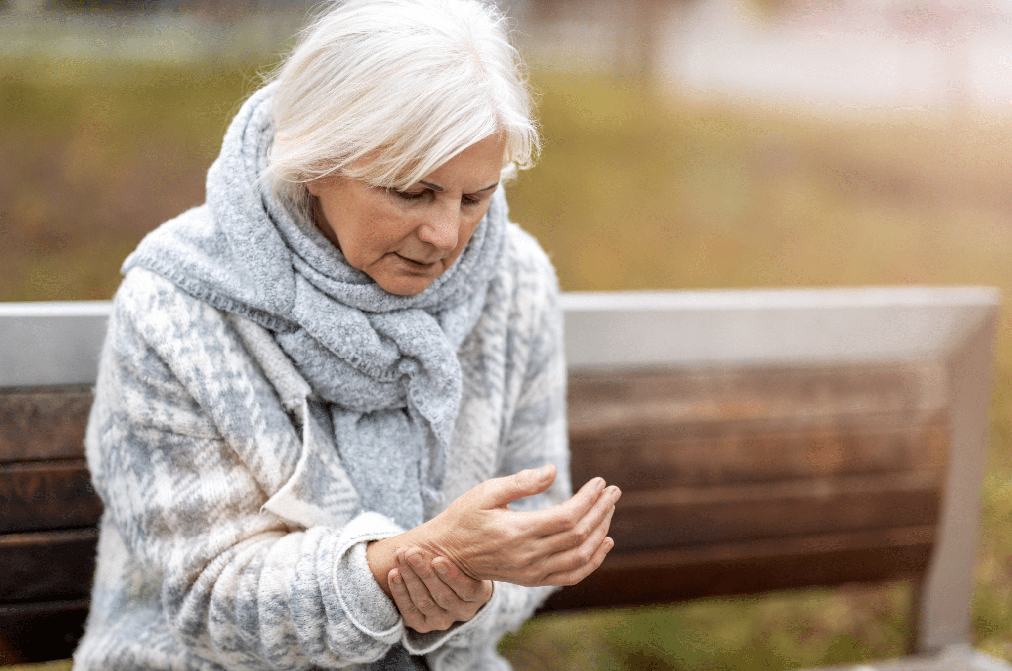 Elderly Woman Suffering With Arthritis Pain In Wrist scaled